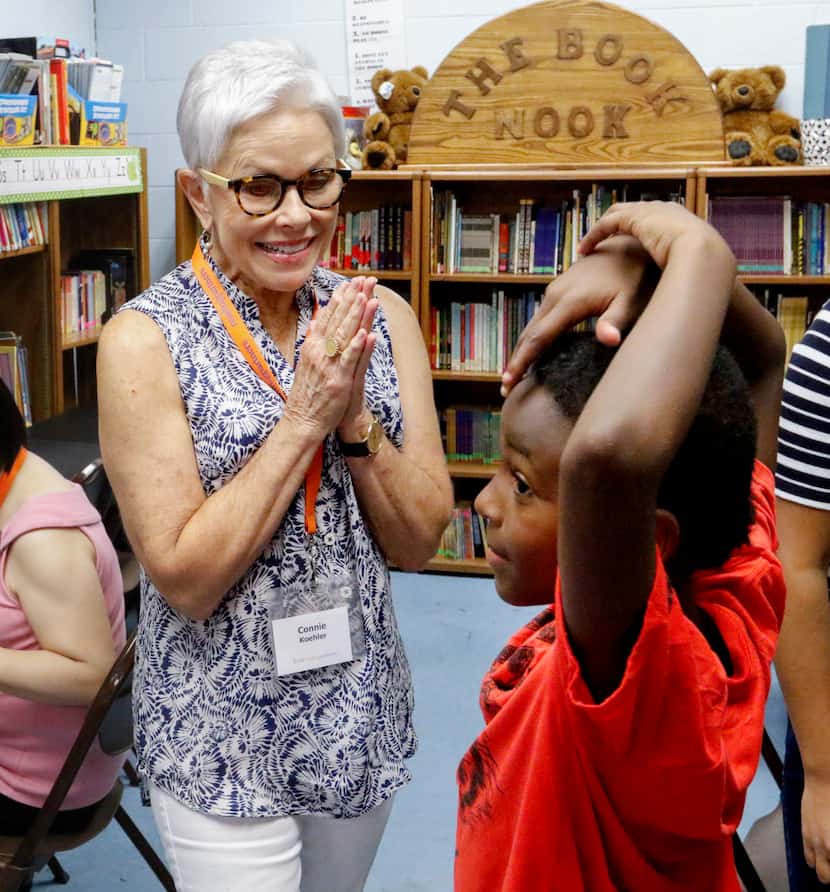 Connie Koehler, 65, a volunteer with Reading Partners, visits with Bradley Williams, 7,...