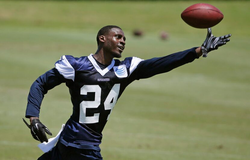 Dallas Cowboys cornerback Morris Claiborne (24) catches the ball as he works by himself...