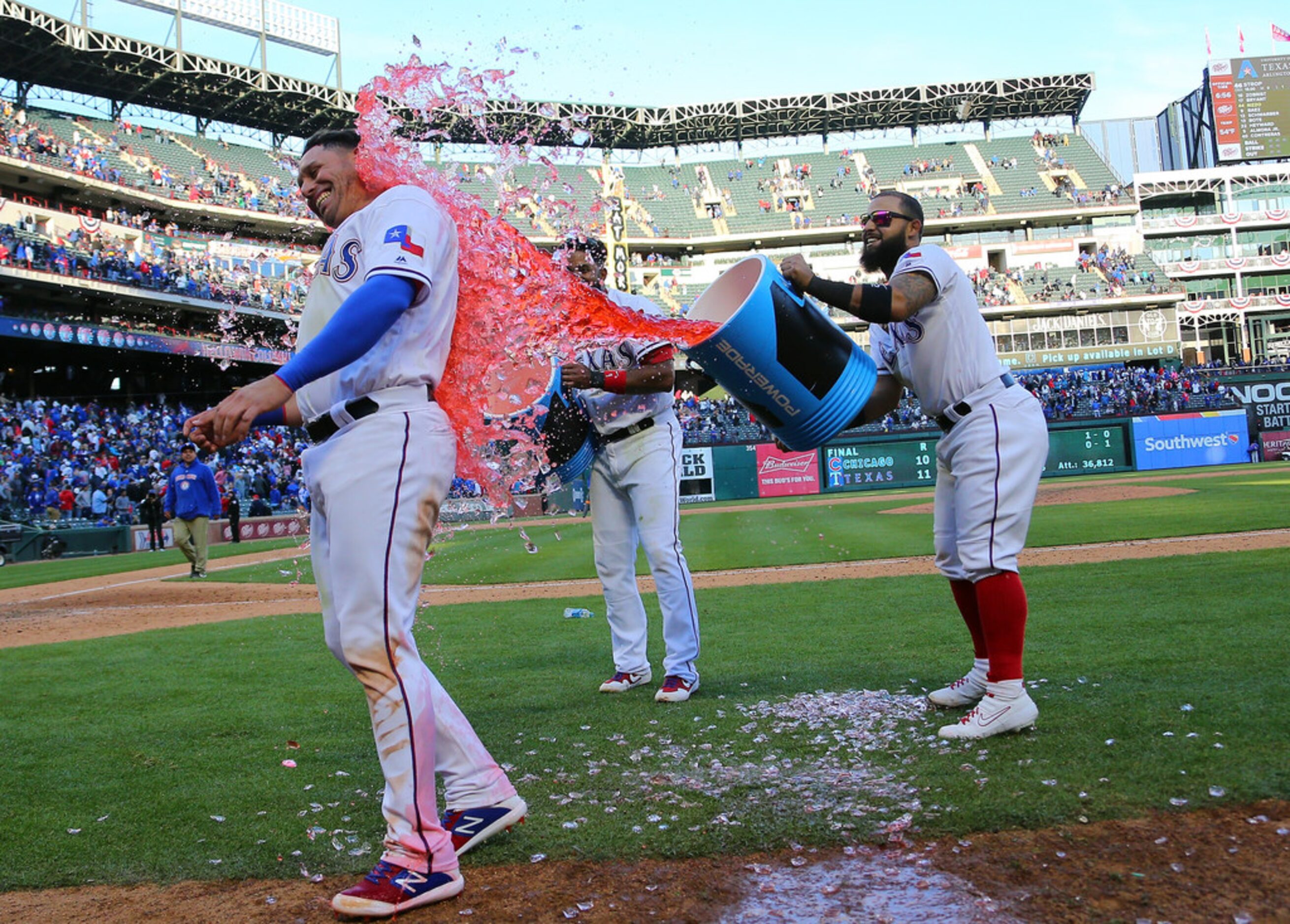 ARLINGTON, TX - MARCH 31: Elvis Andrus #1 of the Texas Rangers and Rougned Odor #12 dump the...