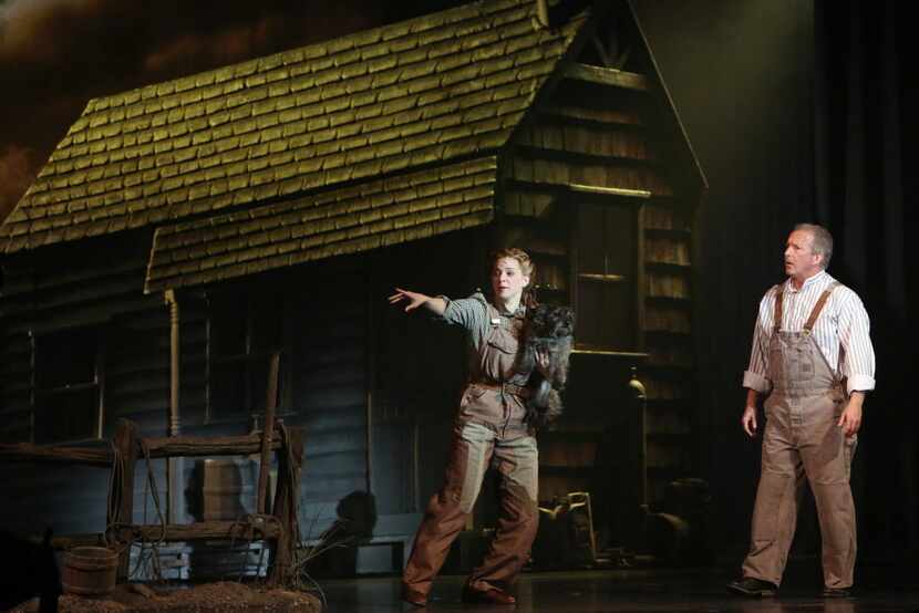 Dorothy (Danielle Wade, left) and Uncle Henry (Larry Herbert, right) perform in opening...