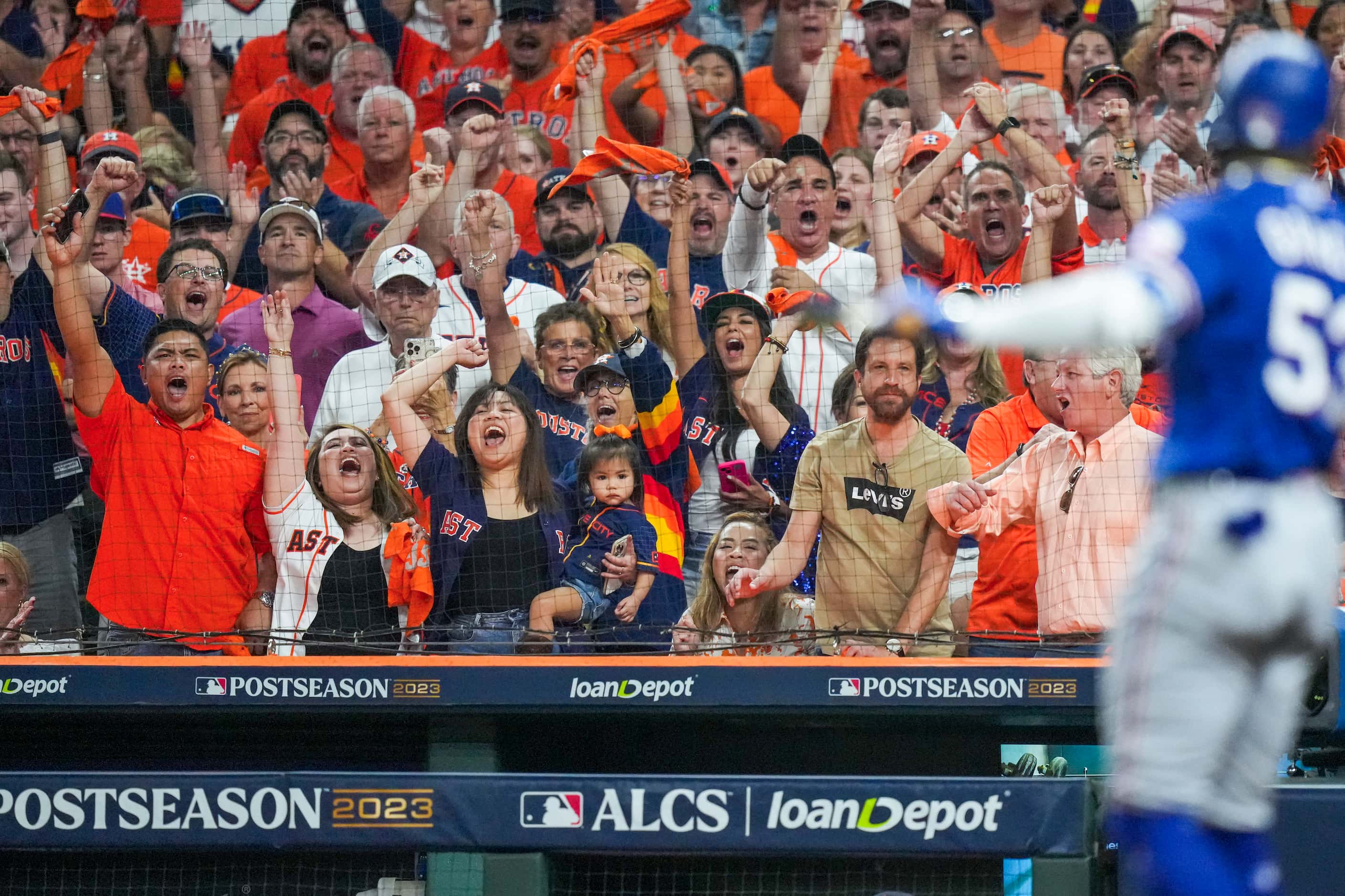Houston Astros fans cheer as Texas Rangers right fielder Adolis Garcia strikes out in the...