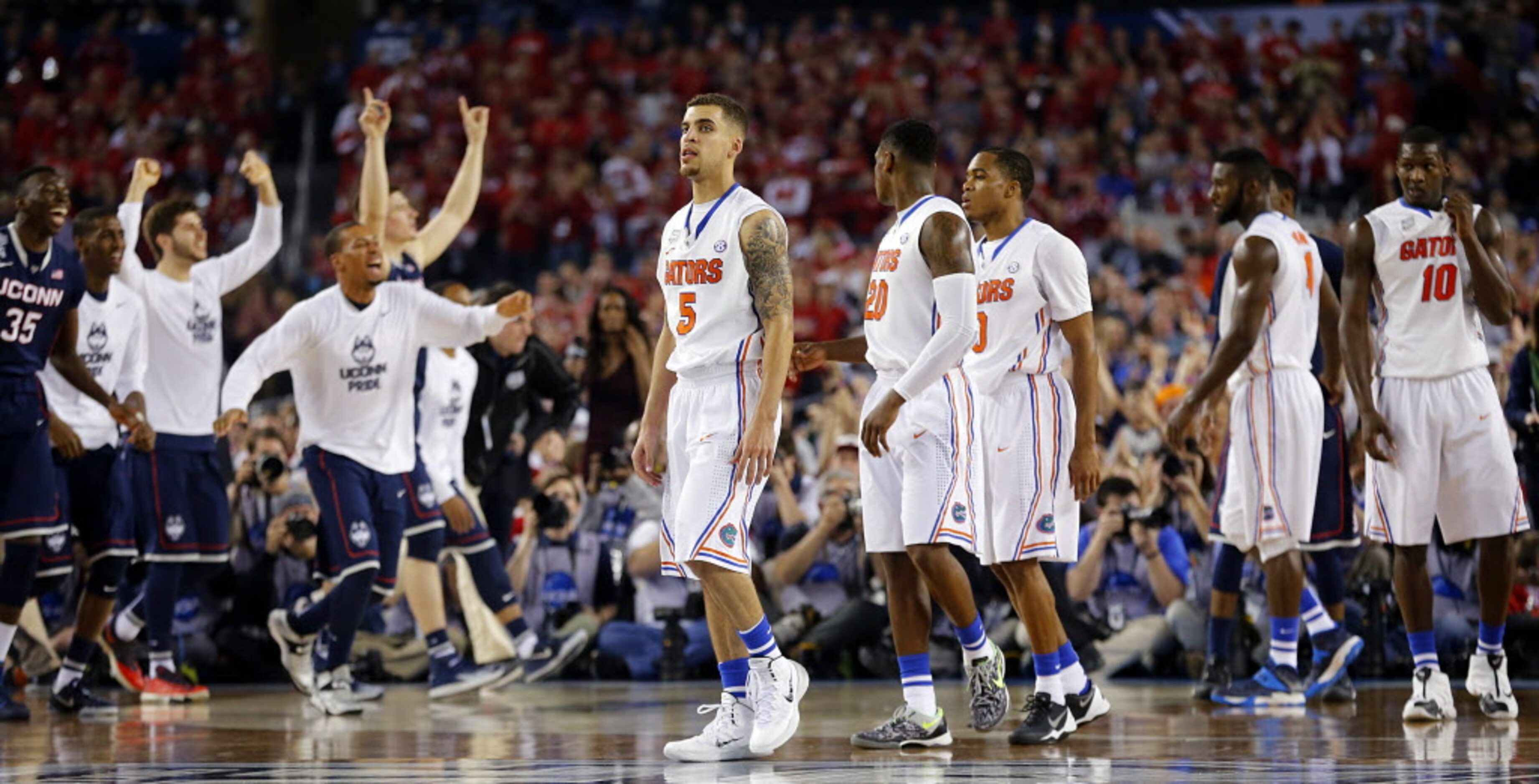 The Florida Gators including guard Scottie Wilbekin (5), guard Michael Frazier II (20), and...