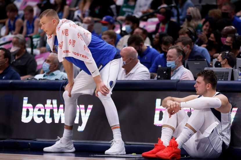 Dallas Mavericks center Kristaps Porzingis (left) and guard Luka Doncic wait to go back in...
