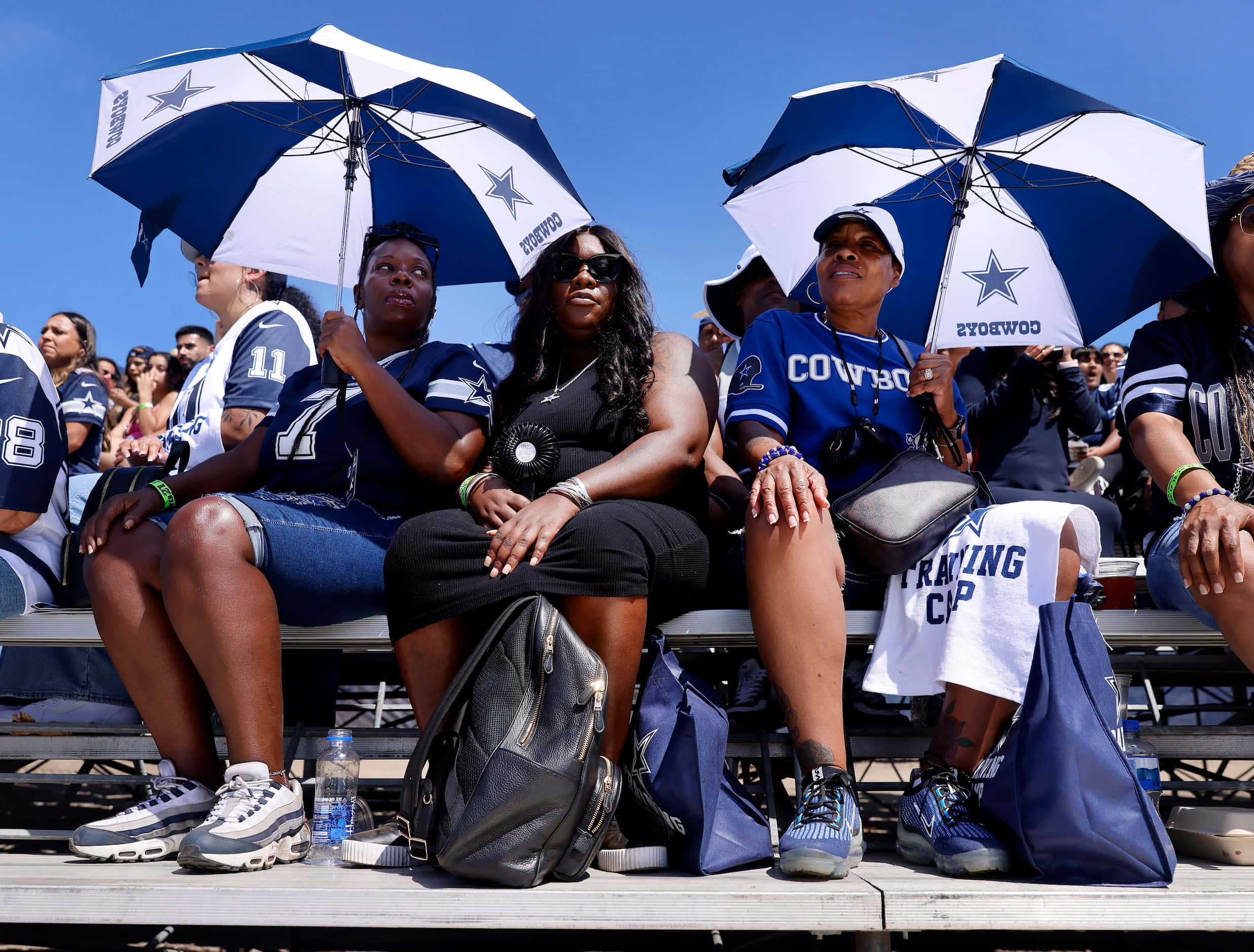 (From left) Shenita Moore, her niece Sheena Richardson and Sherry Tunstall take cover from...