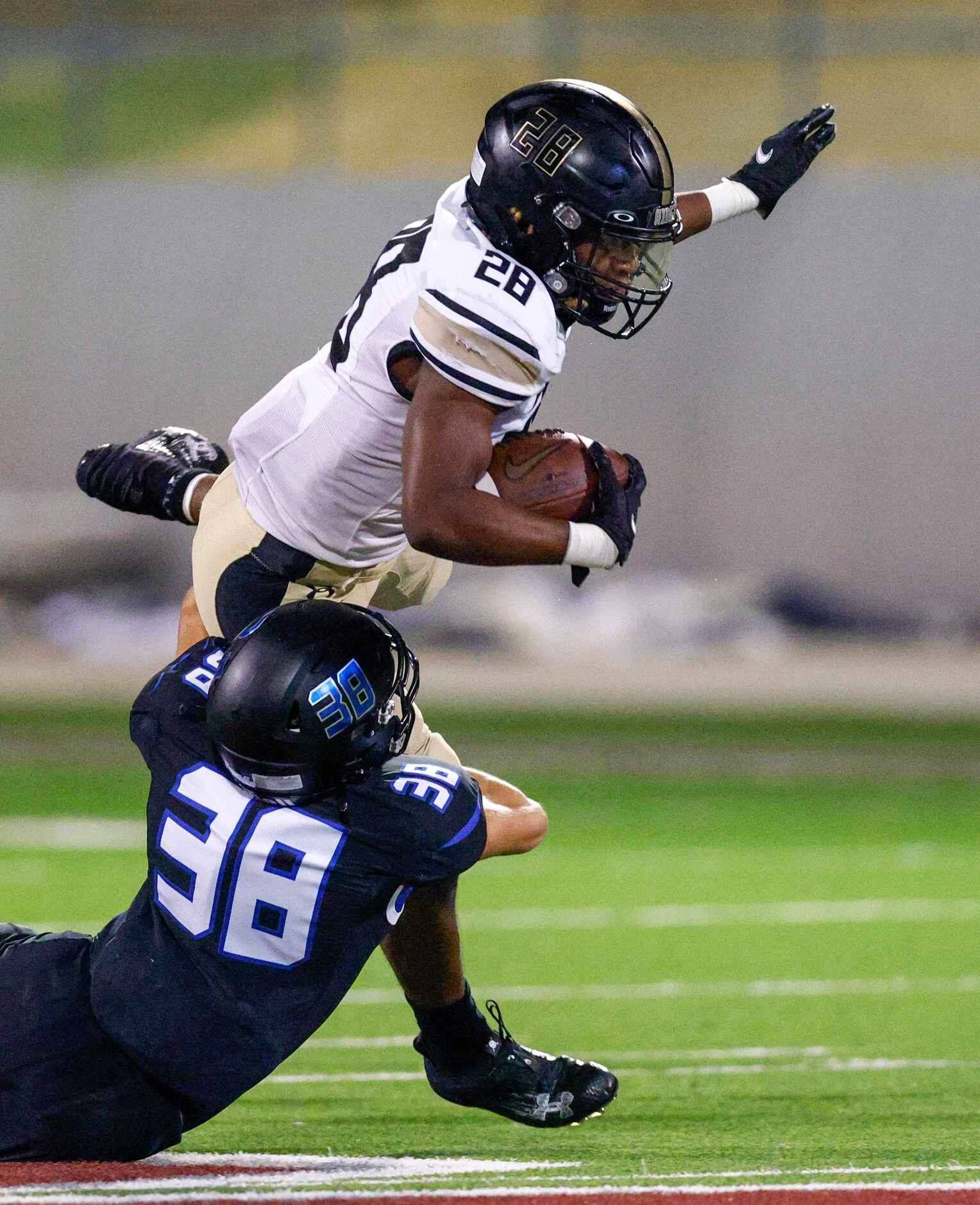 Trophy Club Byron Nelson’s Grayson Tracer (38) tackles Keller Fossil Ridge running back...