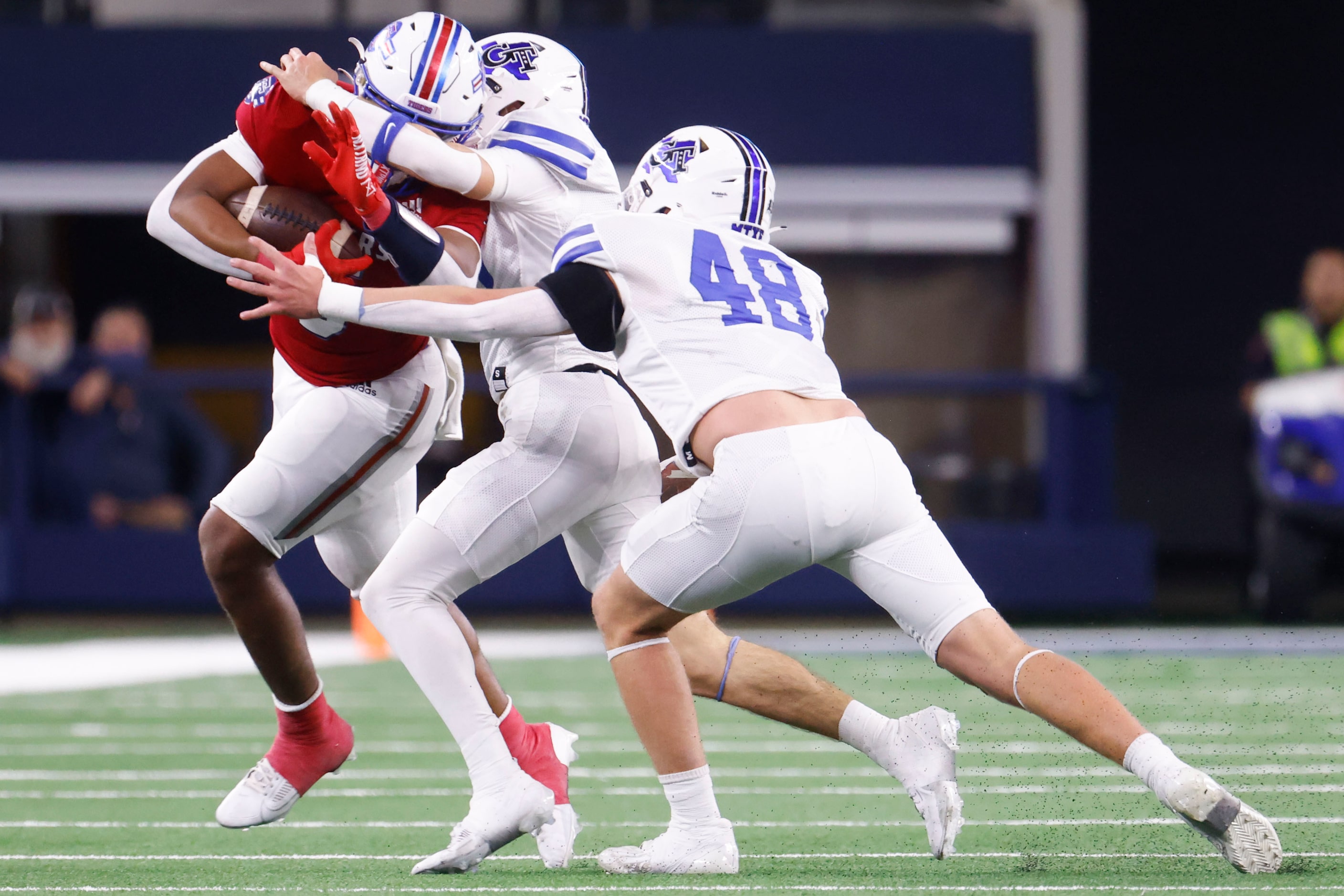 El Maton Tidehaven’s Joseph Dodds (left) gets tackled by  Gunter High’s Colson Wood (center)...