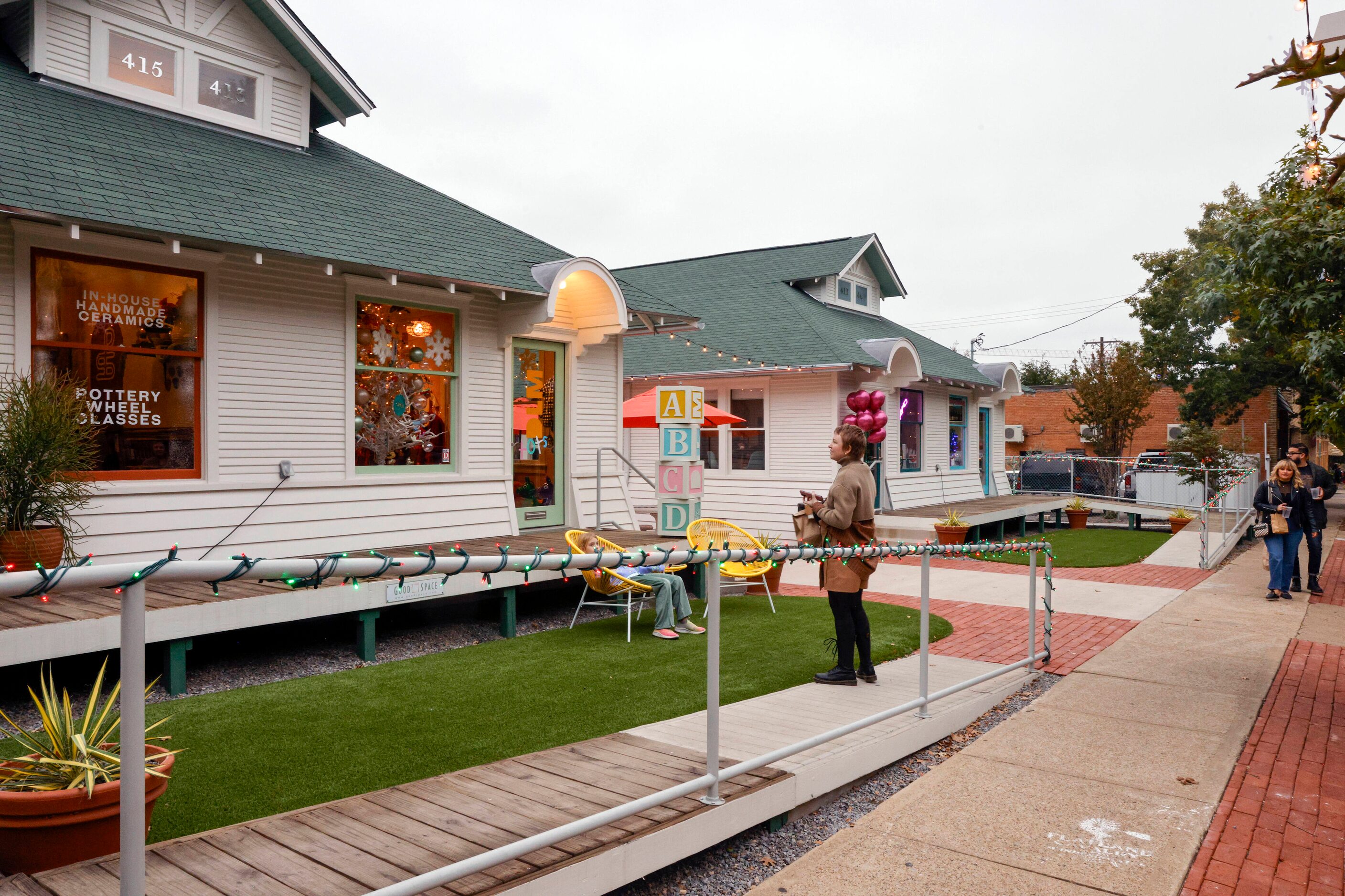 People visit a collection of small businesses in remodeled houses along 8th Street in Bishop...