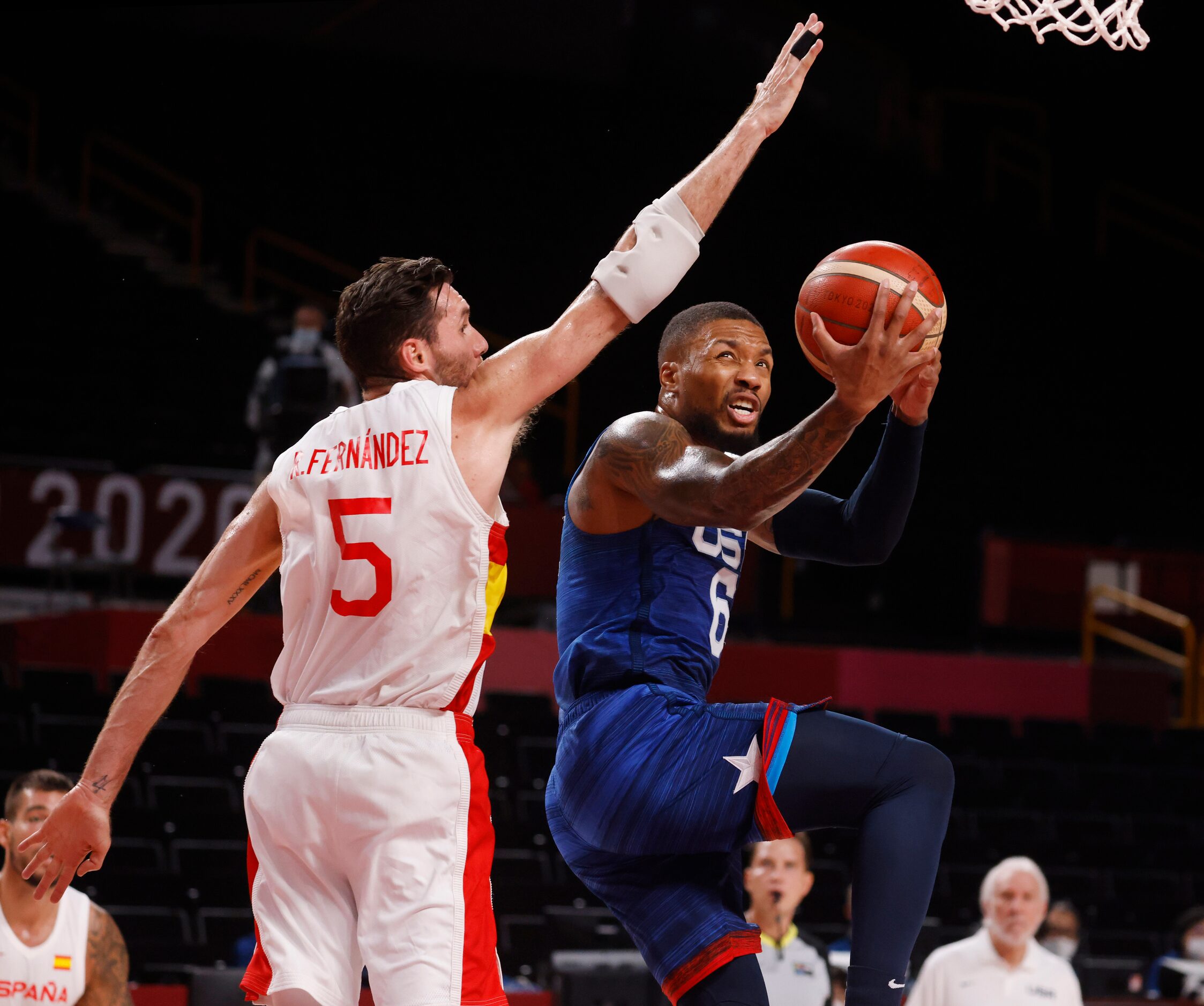 USA’s Damian Lillard (6) attempts a layup in front of Spain’s  Rudy Fernandez (5) during the...