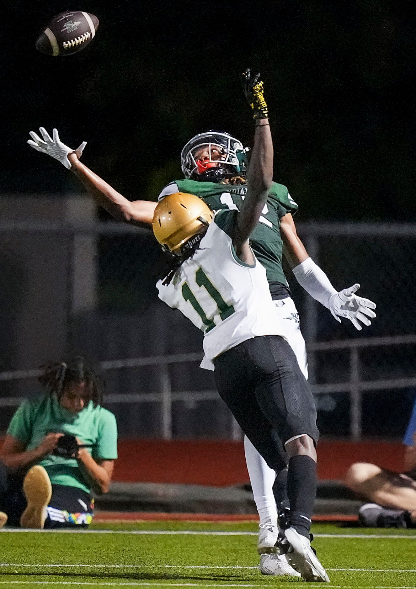 Waxahachie wide receiver Michael Esparza Jr. (12) tips the ball up and comes down with a...