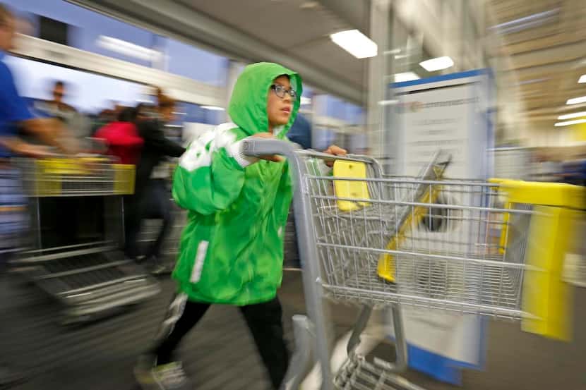 Cesar Coronado, 12, rushes  into a Best Buy in Plano to scoop up Thanksgiving Day bargains....