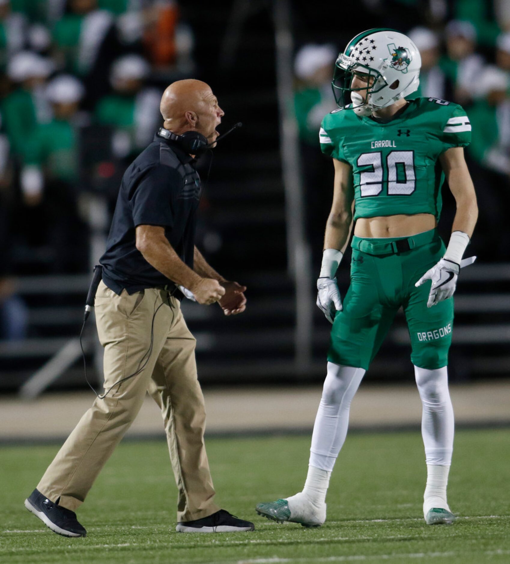 Southlake Carroll defensive coordinator Tim Wasson has a word with Dargons defensive back...