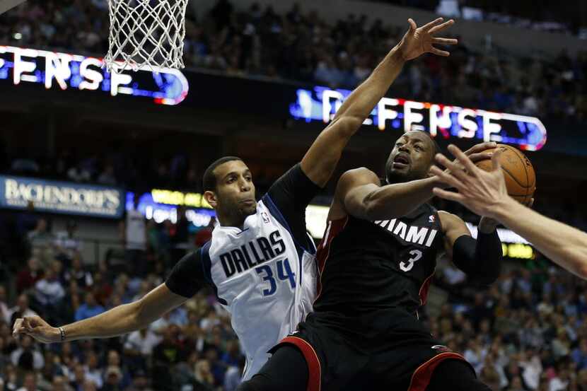 Miami Heat shooting guard Dwyane Wade (3) looks to shoot as Dallas Mavericks power forward...