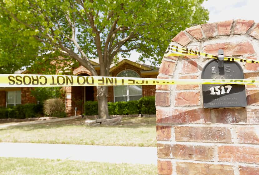 Police tape was wrapped outside the home on Pine Bluff Drive on Monday.