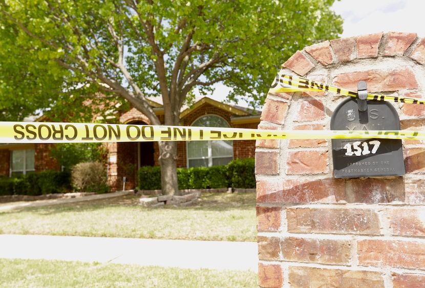 Police tape was wrapped outside the home on Pine Bluff Drive on Monday.