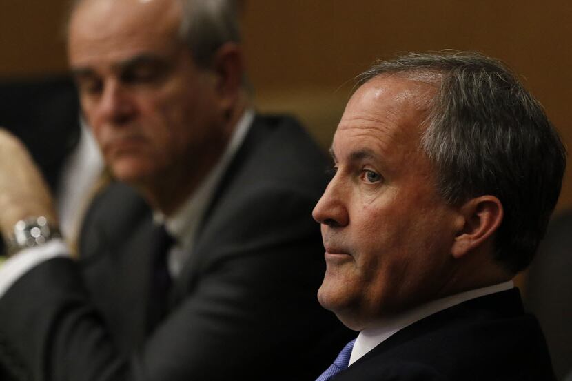 Texas Attorney General Ken Paxton, right, looks at one of the special prosecutors during a...