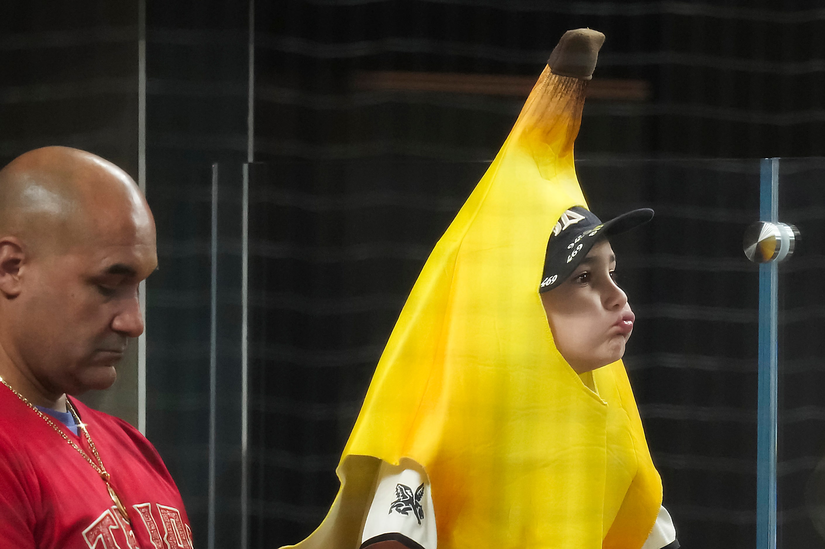 A fan wears a banana suit behind home plate during the sixth inning in Game 4 of the...