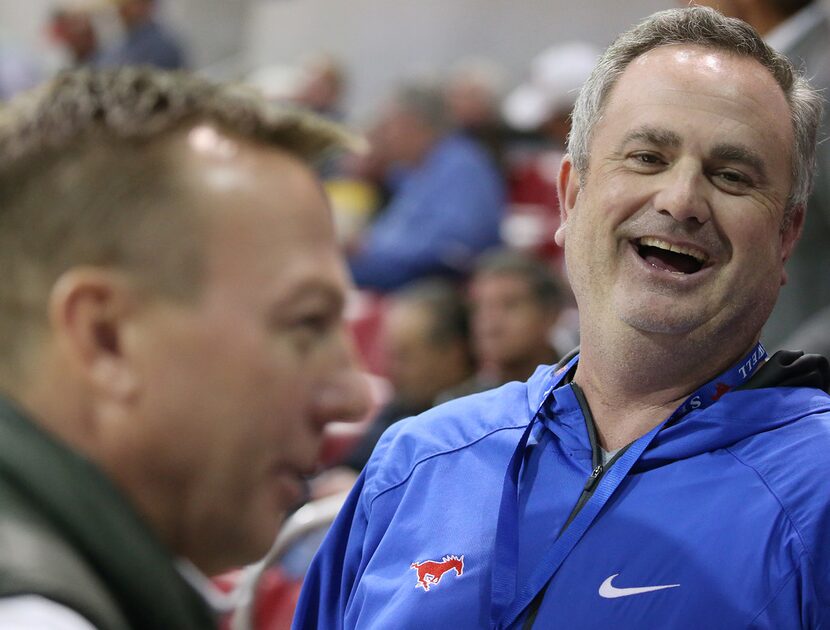 New Southern Methodist Mustangs football head coach Sonny Dykes speaks to patrons before an...