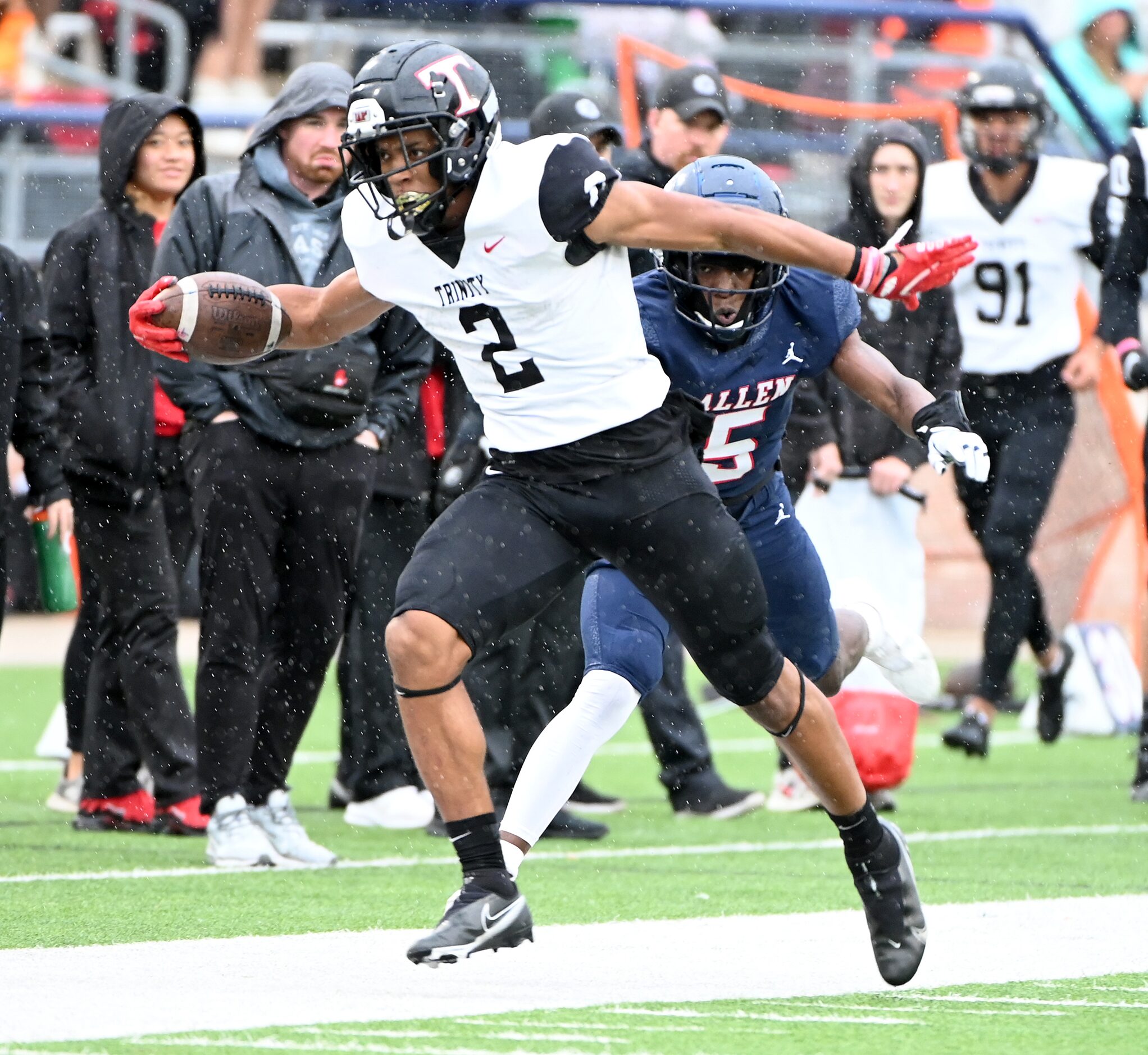 Euless Trinity's Ollie Gordon (2) runs past Allen's Sign Shuva (5) in the first half of...