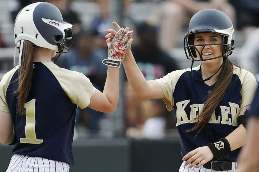 Keller senior Shelby Henderson, right, is congratulated by junior Camryn Woodall (1) after...