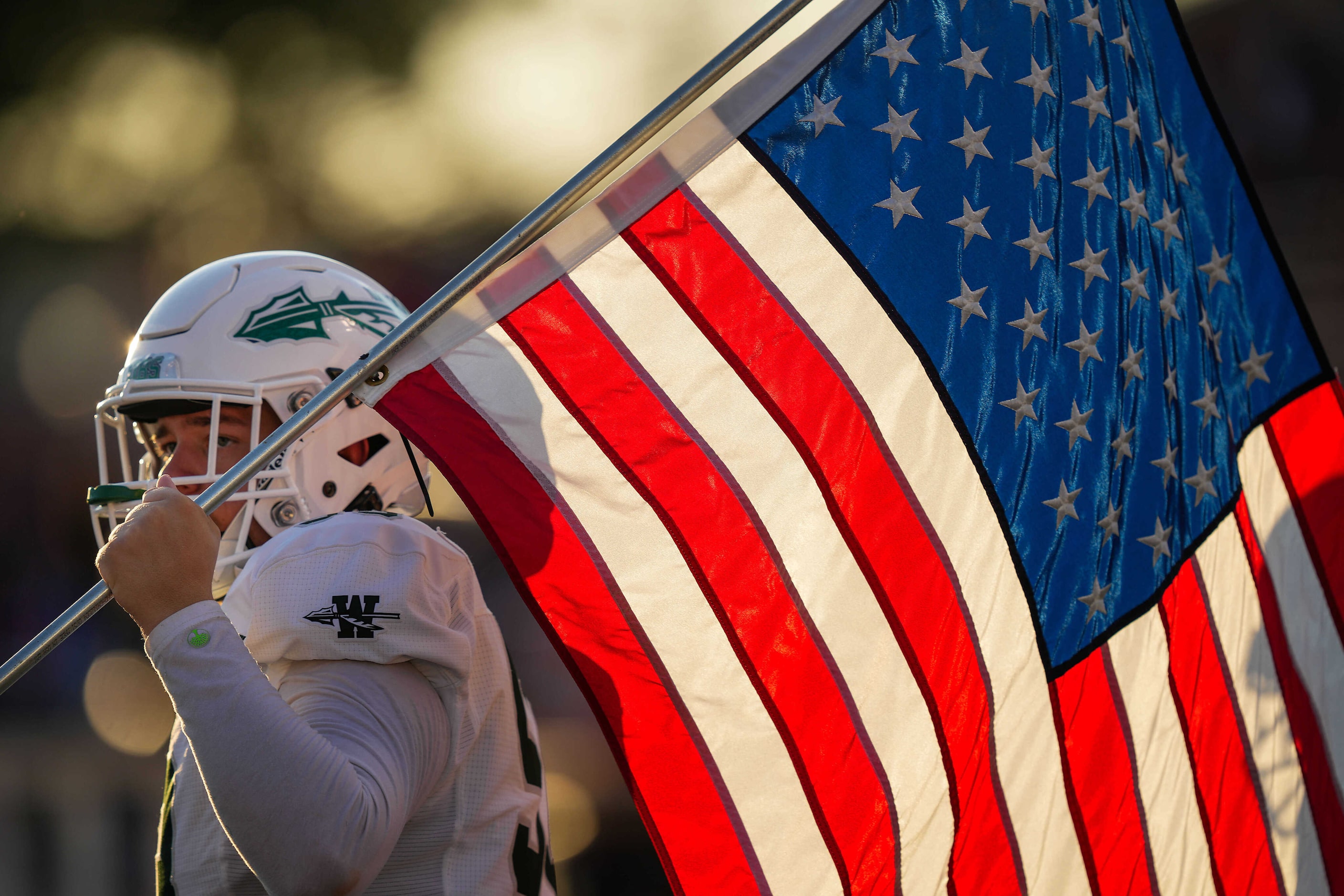 Waxahachie offensive lineman Seth Hicks prepares to lead his team as they take the field for...