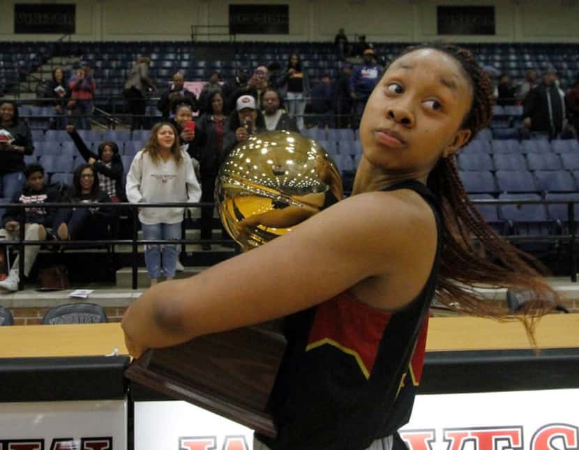 South Grand Prairie forward Camryn Hill (12) glances over her shoulder but not until after...