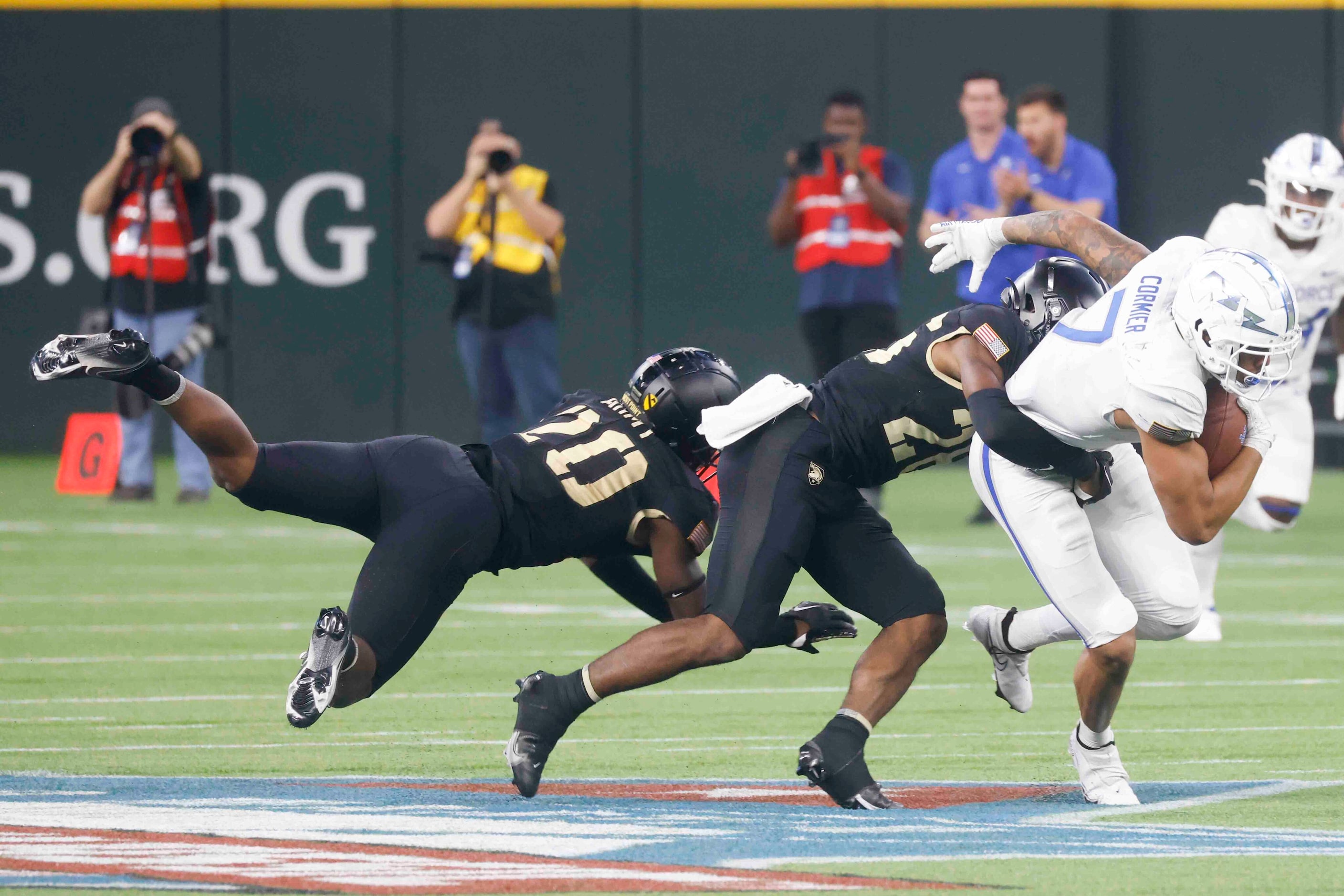 Air Force wide receiver David Cormier (7), right, gets tackled by Army defensive back...