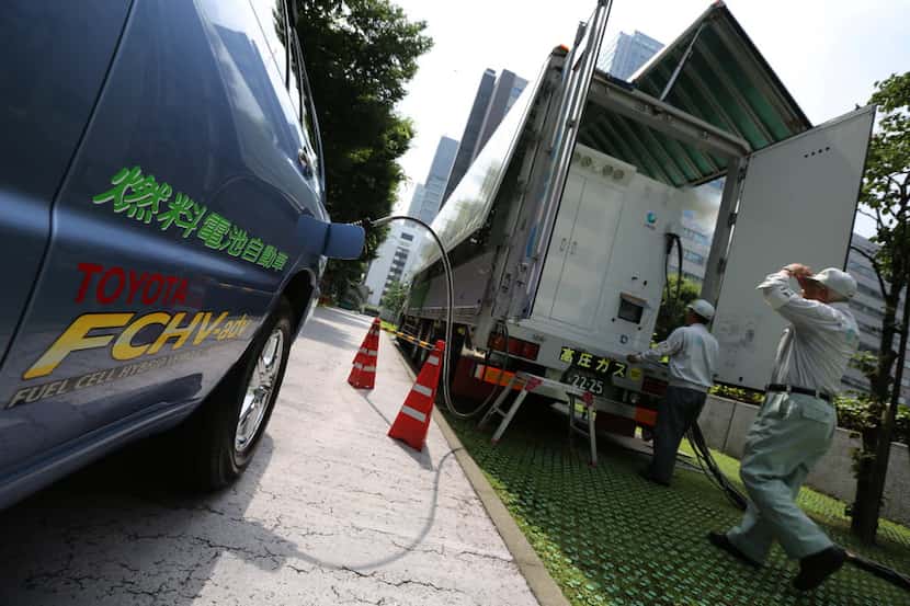 In this July 14, 2014 photo, a Toyota fuel cell hybrid vehicle is refueled from a mobile...