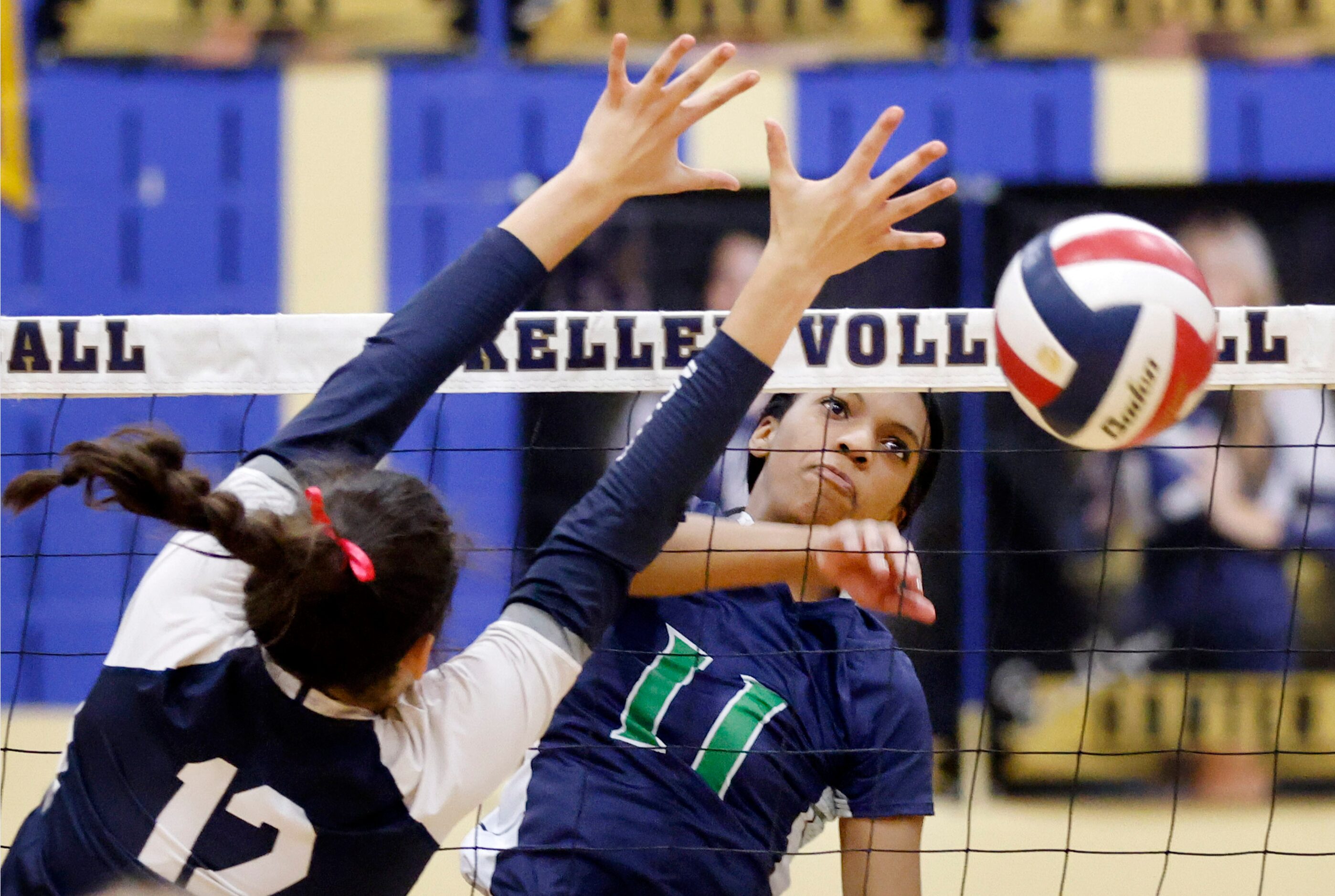 Eaton High’s Kimaya Webb (11) spikes the ball past Keller High’s Anna Flores (12) during the...