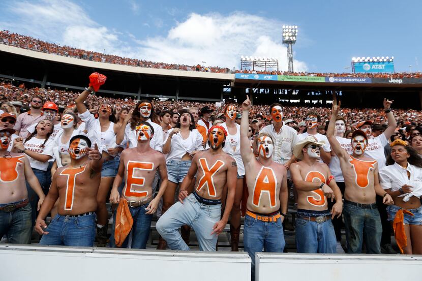 Texas Longhorns fans cheer for their team during the second half of play at the Cotton Bowl...