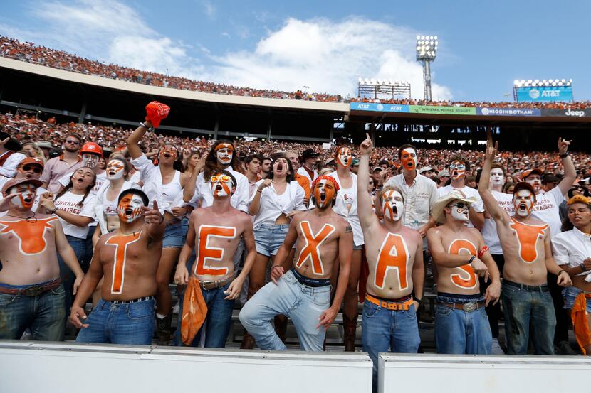 Texas Longhorns fans cheer for their team during the second half of play at the Cotton Bowl...