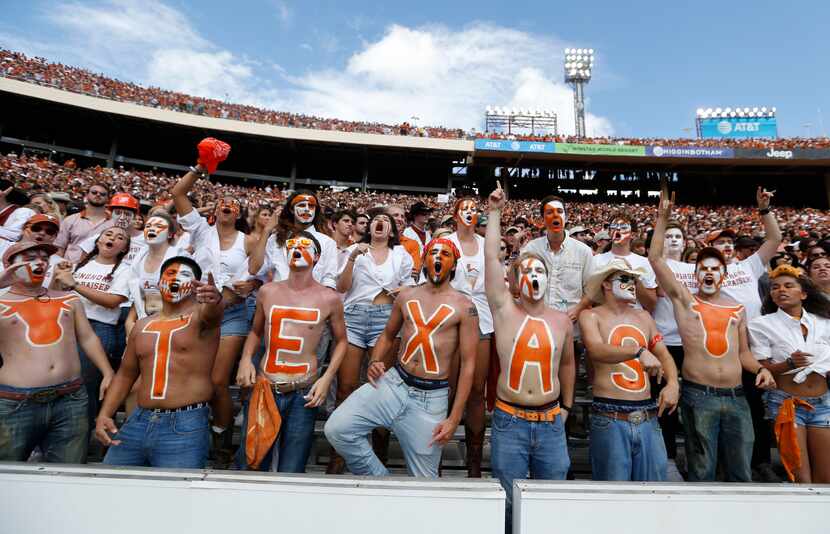 Texas Longhorns fans cheer for their team during the second half of play at the Cotton Bowl...