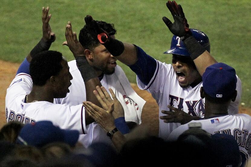 Texas Rangers right fielder Nelson Cruz (17) arrives at the dugout after clubbing his second...
