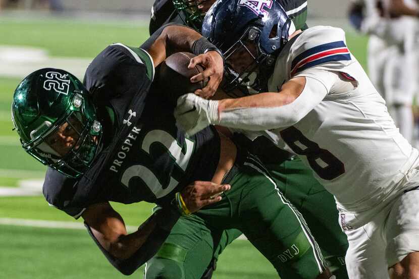 Prosper's Leo Anguiano (22) tries to run through a tackle attempt by Allen's Drew King (8)...