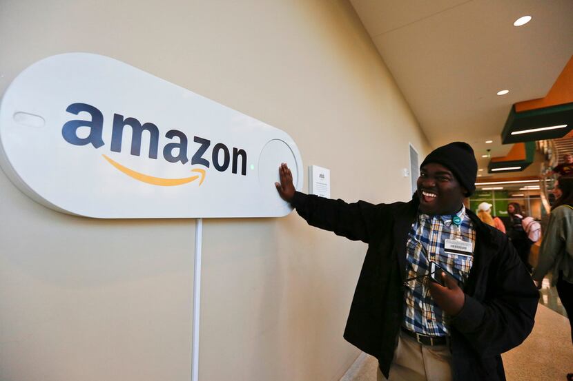 Zavian Tate, a student at the University of Alabama at Birmingham, pushes a large Amazon...