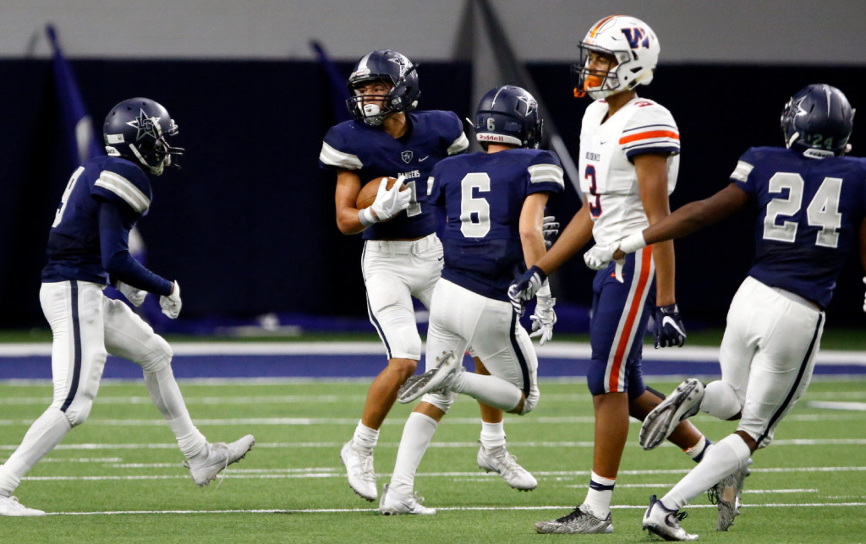 Frisco Lone Star High Nick Kitchens (1) looks around for flags after intercepting a pass...