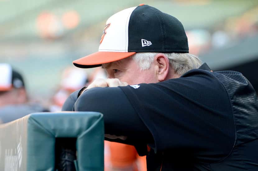 BALTIMORE, MD - JULY 13: Manager Buck Showalter #26 of the Baltimore Orioles watches the...