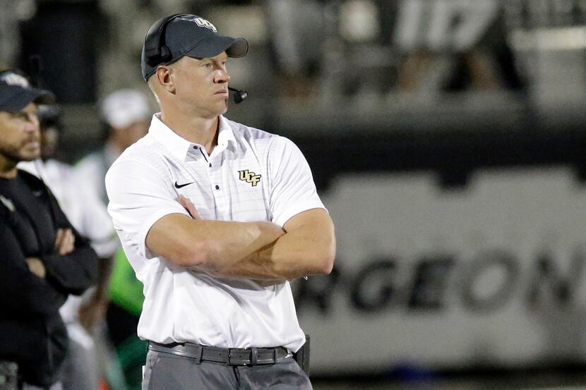 FILE - In this Aug. 31, 2017, file photo, Central Florida head coach Scott Frost watches his...
