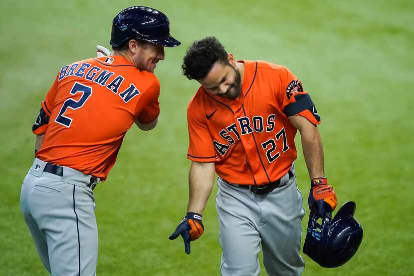 Houston Astros second baseman Jose Altuve celebrates with third baseman Alex Bregman after...
