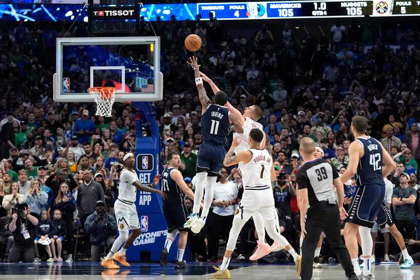 Dallas Mavericks guard Kyrie Irving (11) shoots the winning final-second basket against...