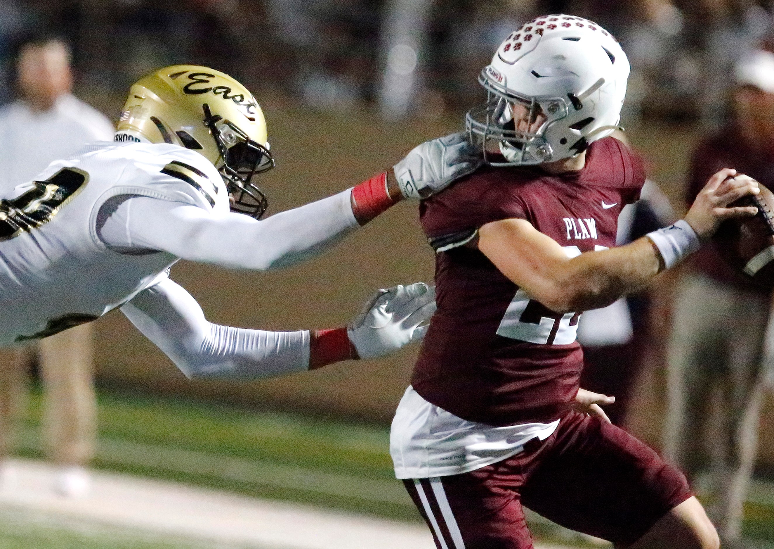 Plano East High School defensive end Chima Chineke (40) gets the facemask of Plano Senior...