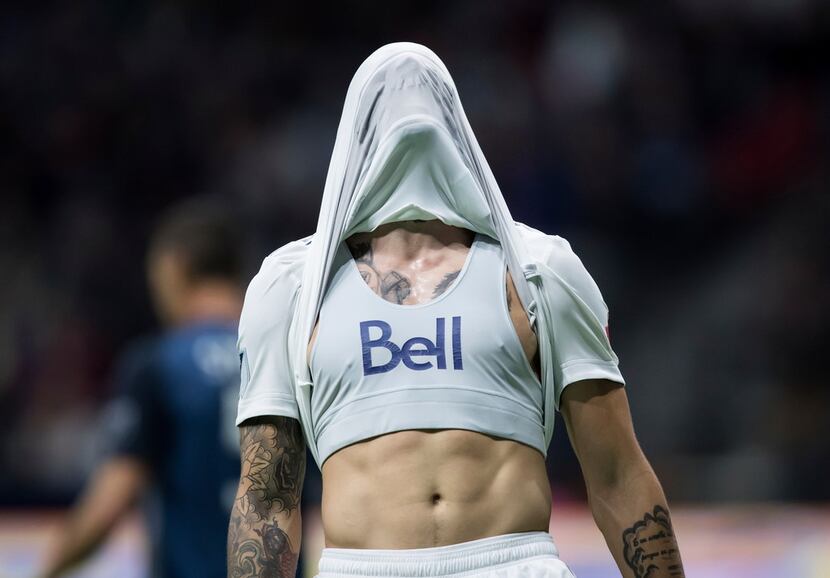 Vancouver Whitecaps' Joaquin Ardaiz covers his head with his jersey after a missed scoring...