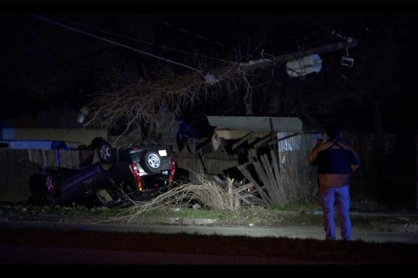 An SUV lies overturned after striking a utility pole in Fort Worth on Friday morning. The...