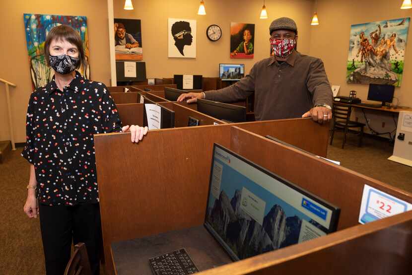 Cameron Kainerstorfer, a public services librarian, and library assistant Alfred Biley, Jr.,...