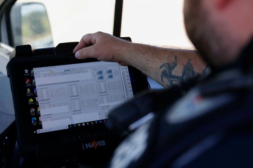 Dallas Animal Services officer Reid Koenig checks his calls ahead of his shift on Wednesday,...