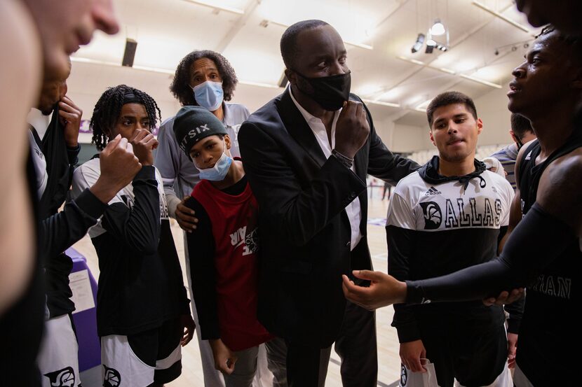 Dallas Christian College basketball coach Dwight Coleman (center right) huddles with his...