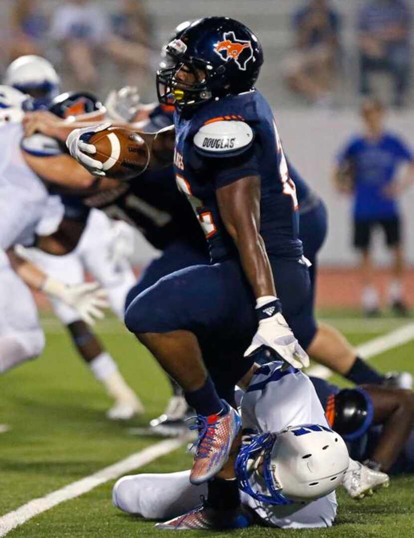 Sachse High School running back Devine Ozigbo (22) was able to break this tackle attempt by...