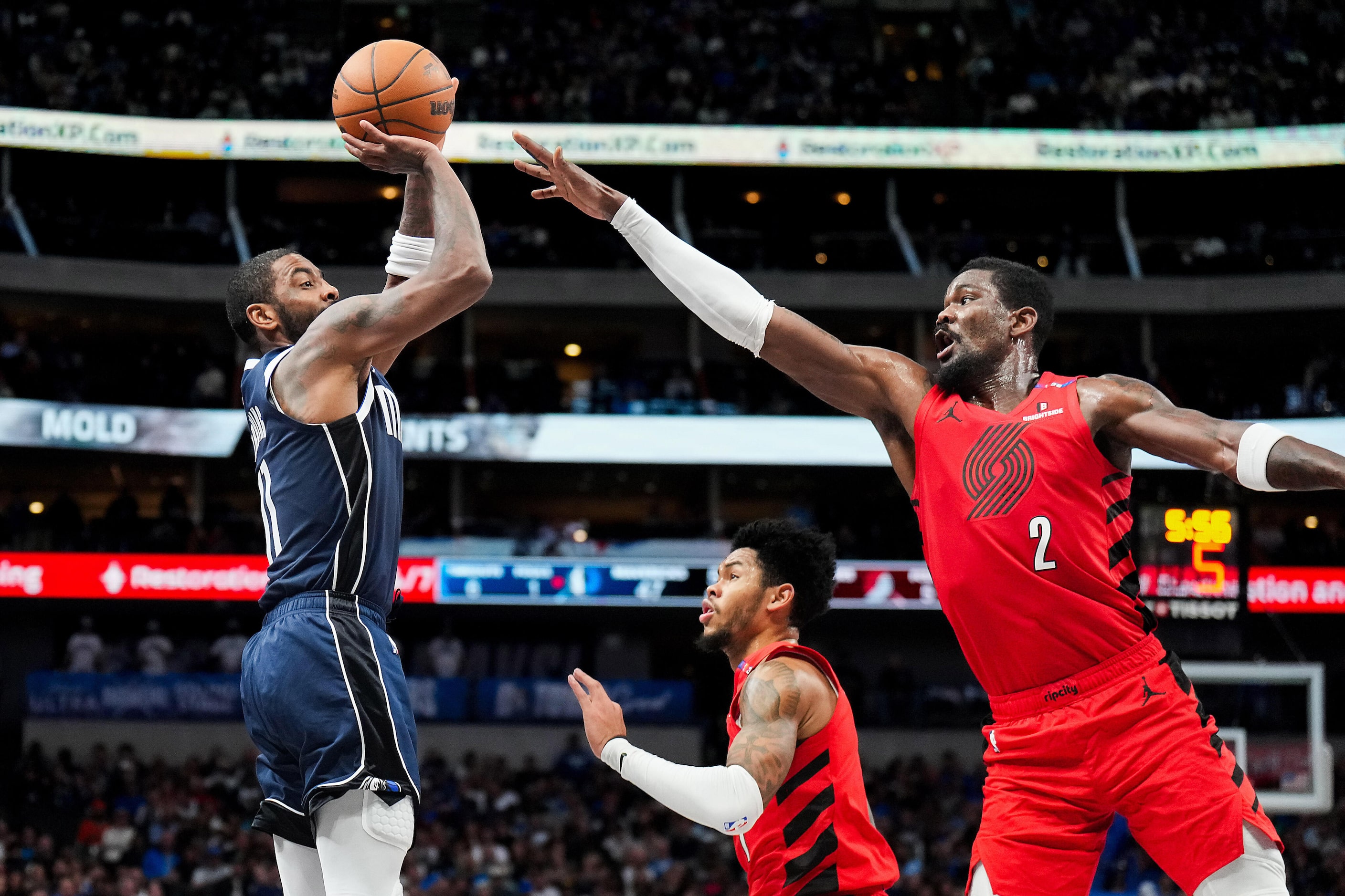 Dallas Mavericks guard Kyrie Irving (11) shoots over Portland Trail Blazers center Deandre...