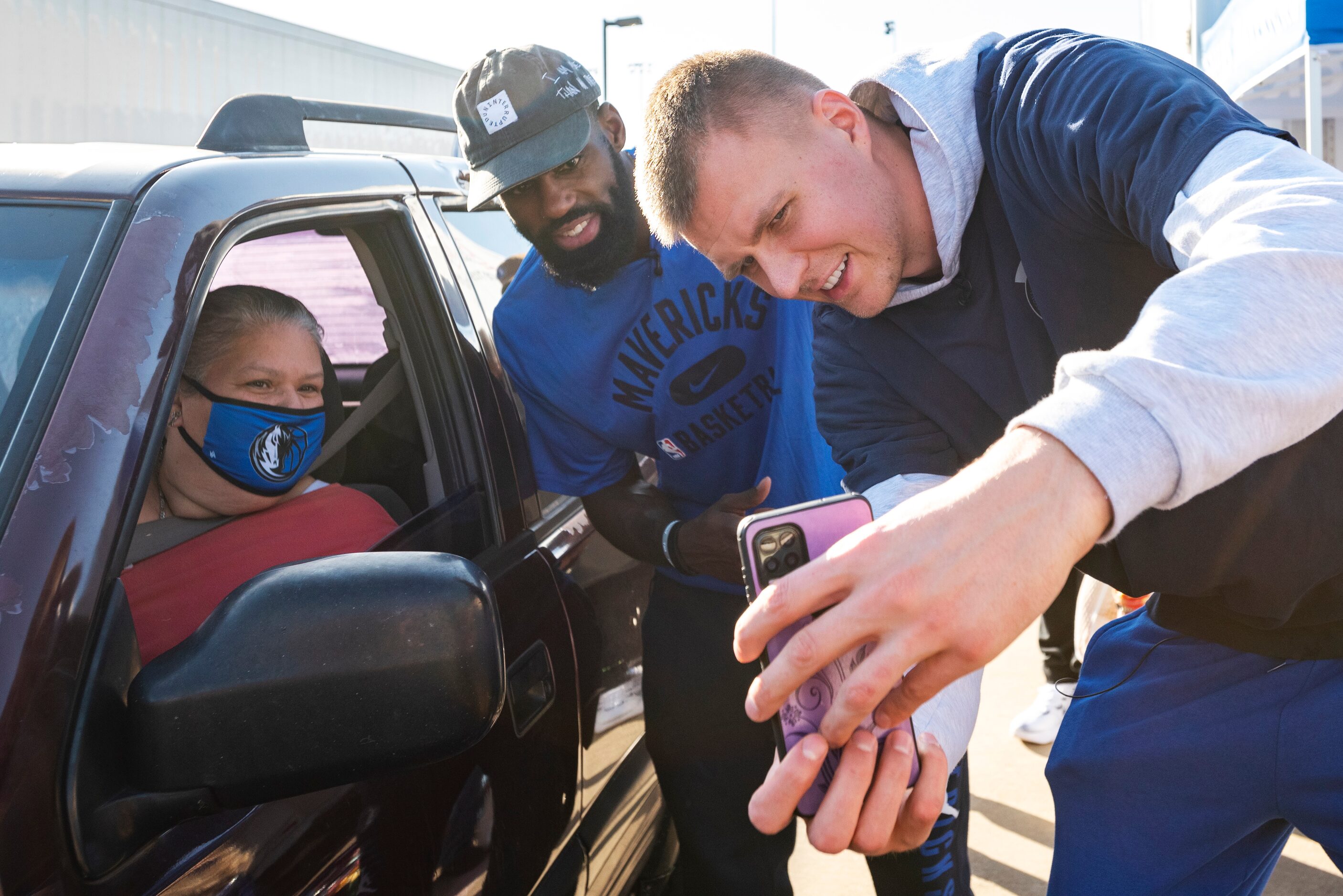 Dallas Mavericks players Tim Hardaway Jr., center, and Kristaps Porzingis, right, take a...