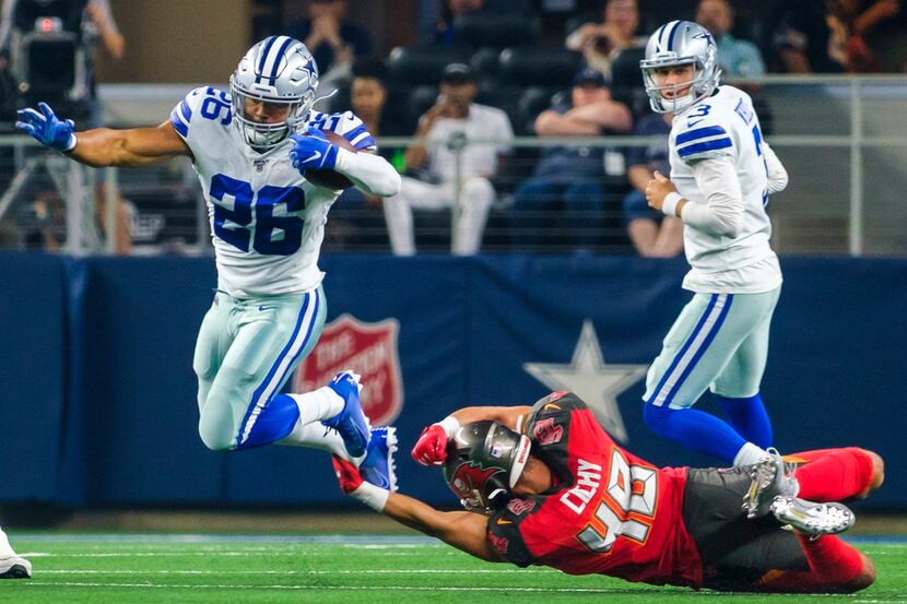 Dallas Cowboys running back Darius Jackson (26) is tripped up by Tampa Bay Buccaneers...