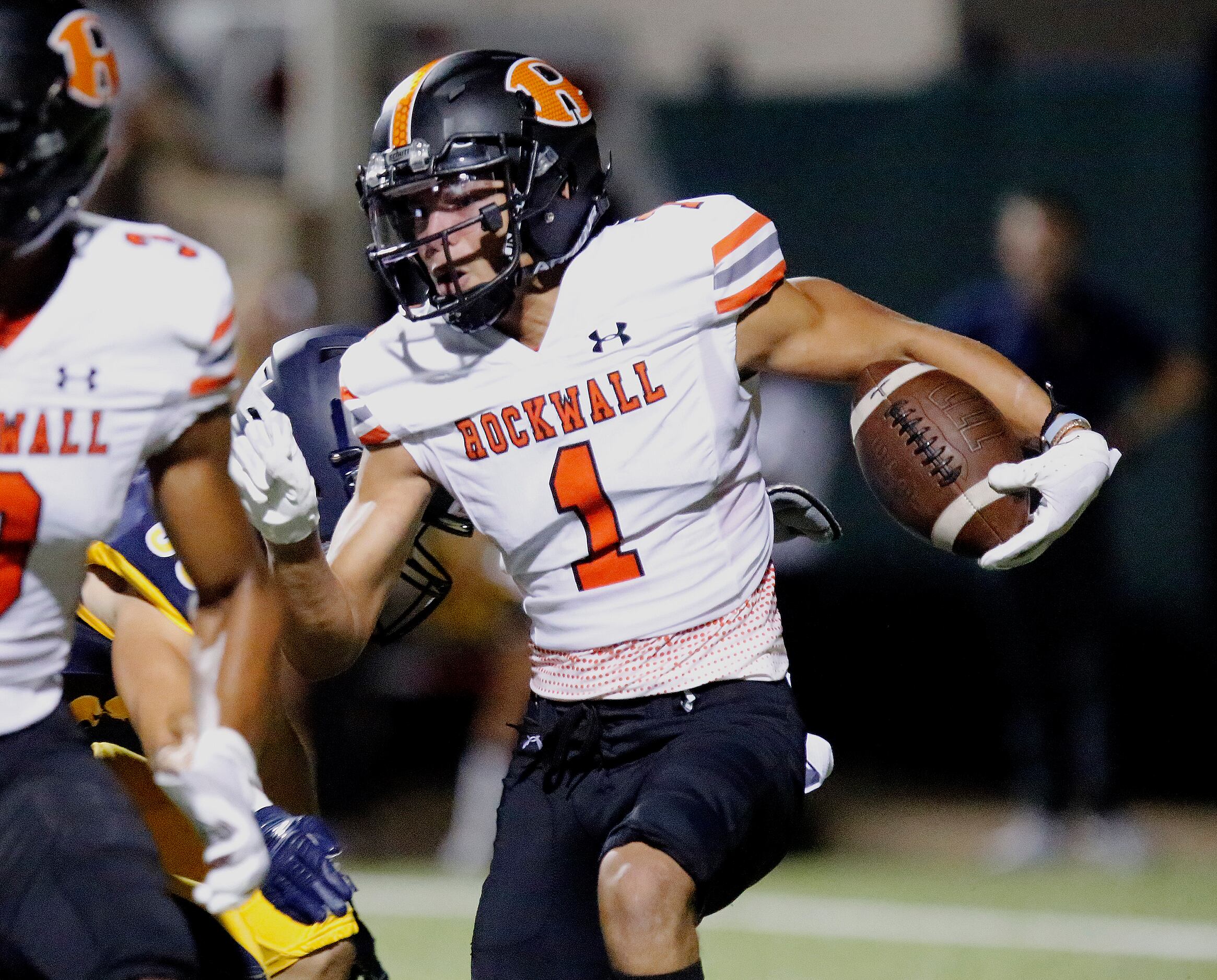 Rockwall High School wide receiver Aiden Meeks (1) returns a kickoff during the first half...